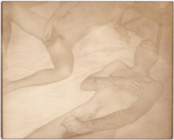 Unusual vintage photo of two naked guys lying on a mattress on the floor. 