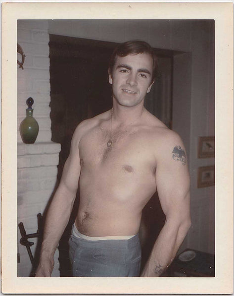 Vintage gay Polaroid Handsome broad-shouldered guy with a little patch of chest hair, a medallion, and an eagle tattoo with the word "Lyn." 