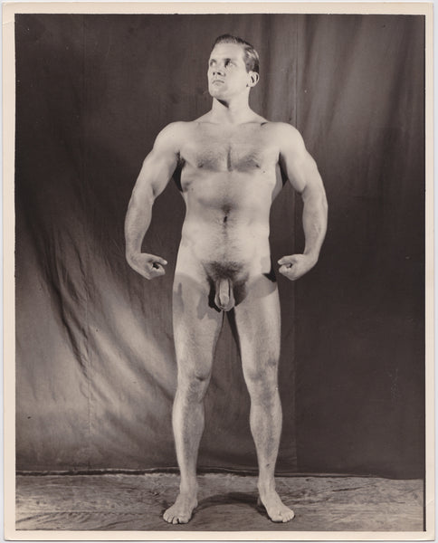 Original vintage photo of a handsome and beefy male model in the studio