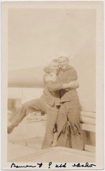 Two sailors in a tight embrace vintage sepia snapshot. Gay interest.