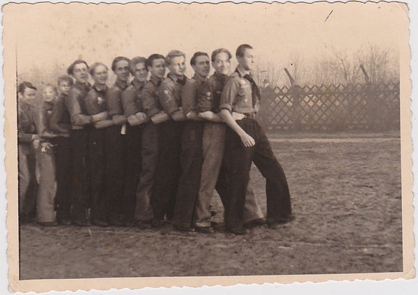 Vintage snapshot A dozen young (Estonian?) men arranged from tallest to shortest with arms tight