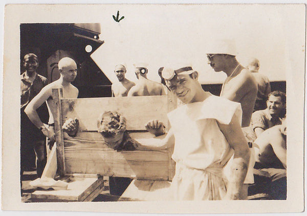 vintage sepia photo during the Crossing the Line ceremony, this sailor is humiliated by a shellback.