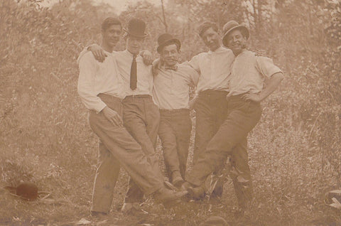 vintage snapshot five guys with feet together.