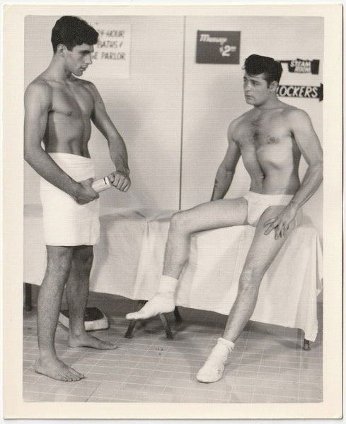 Original vintage gay photo of two nearly naked guys deciding who's going to massage who. By Chuck Renslow - Kris Studio, Chicago.