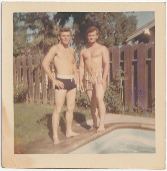 Soft focus snapshot of two guys (brothers?) standing next to a pool vintage gay snapshot 1970