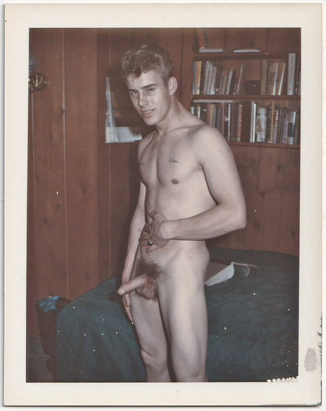 Male nude with a couple illlegible tattoos sports a Greaser "Elephant Trunk" hairdo. Vintage gay Polaroid c. 1960s.