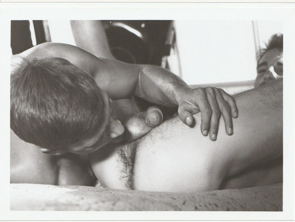 Bob Bishop tasting Al Parker in the back of their van.  Vintage gay photo.