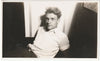 Handsome doe-eyed guy sits on the floor with his shirtsleeves rolled up.
vintage gay photo 1945.