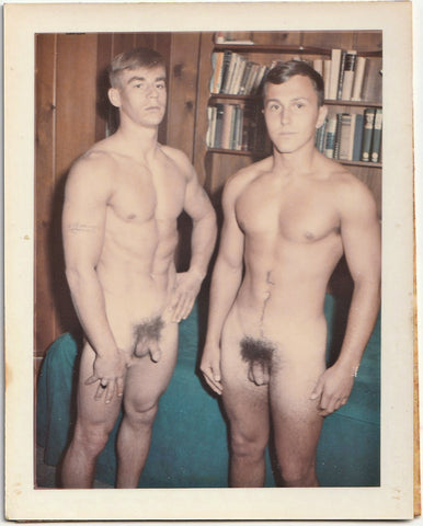 Vintage Polaroid gay photo Two naked muscle studs stand in the library.