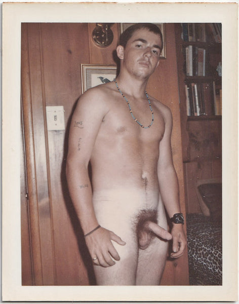 Male nude with "Love," "Sex," and "Blue" tattoos scattered across his right arm. vintage gay Polaroid c. 1960s.
