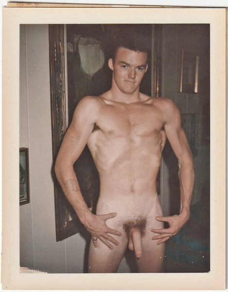 Male nude holds his breath as he does a vacuum pose. Vintage gay Polaroid c. 1960s.