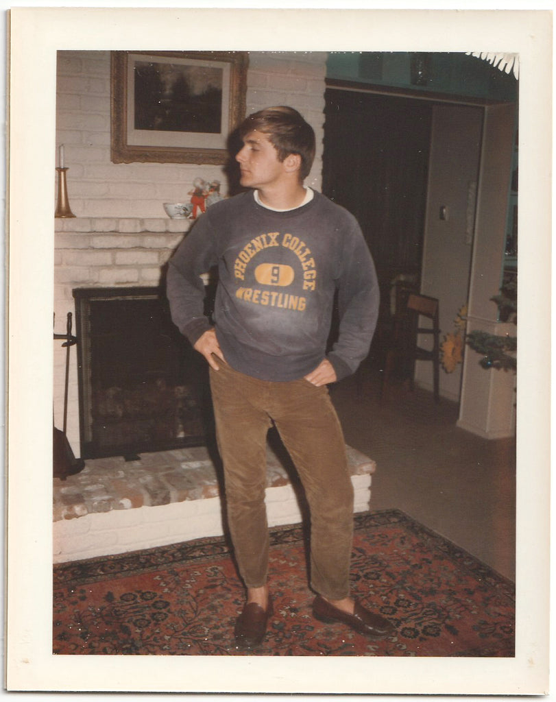 Handsome stud wears his wrestling sweatshirt prior to removing it and the rest of his clothes.
