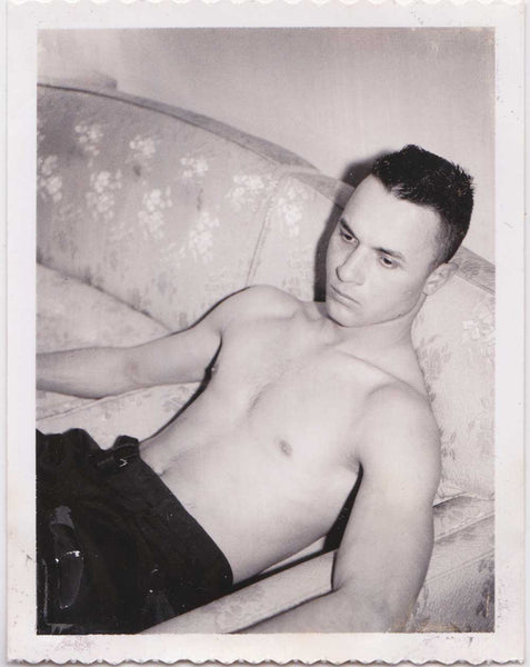 handsome young man has relaxed enough to remove his shirt and tie. vintage gay Polaroid