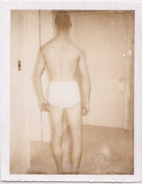 Vintage gay Polaroid Beefy guy standing in his tighty-whiteys with his back to the camera.