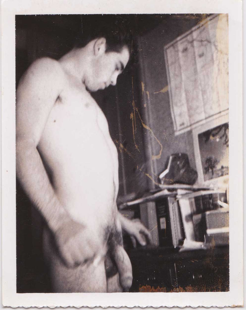 Vintage Polaroid Naked man looking at a desk or bookshelf.