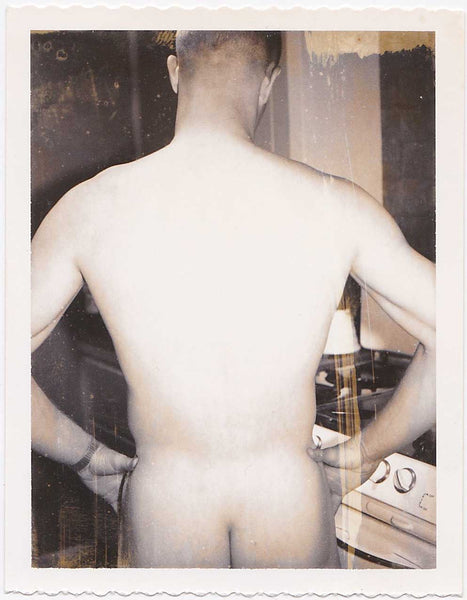 Male nude standing next to the stove, viewed from the side vintage gay Polaroid