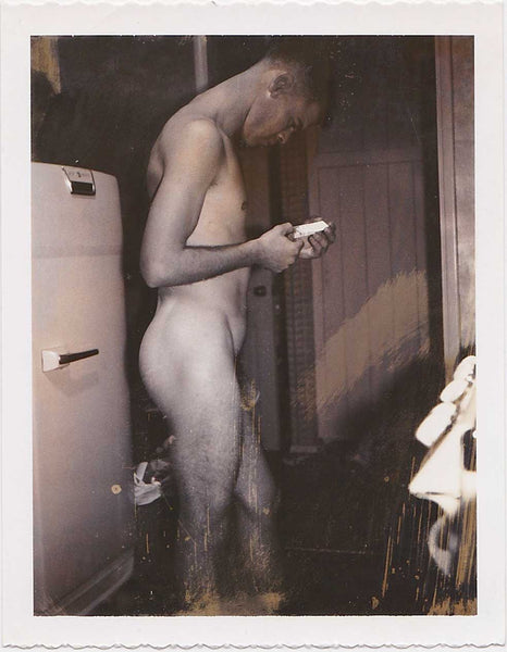 Male Nude Looking at Polaroid