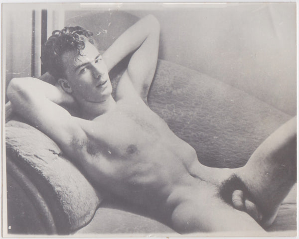 Unidentified male nude lounges on a chaise. vintage gay photo