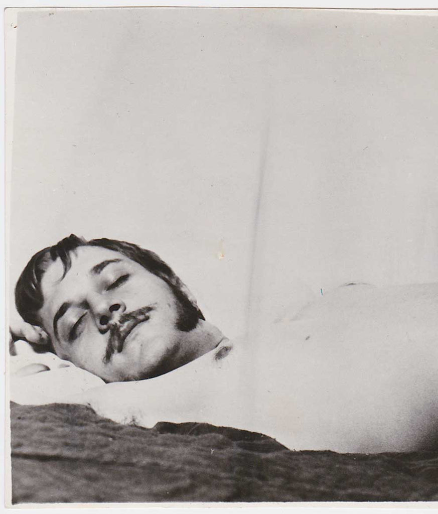 Vintage gay photo of a handsome guy with mustache, long sideburns and an impressive erection.
