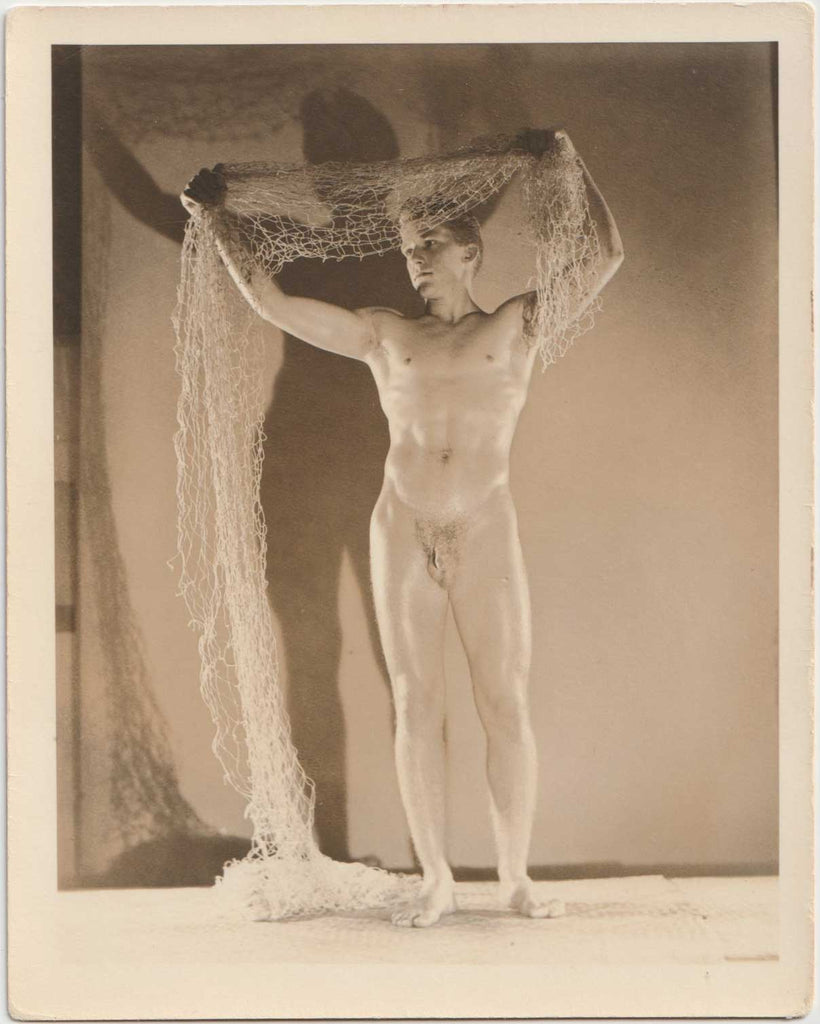 Vintage photo of a handsome male model holding a net.