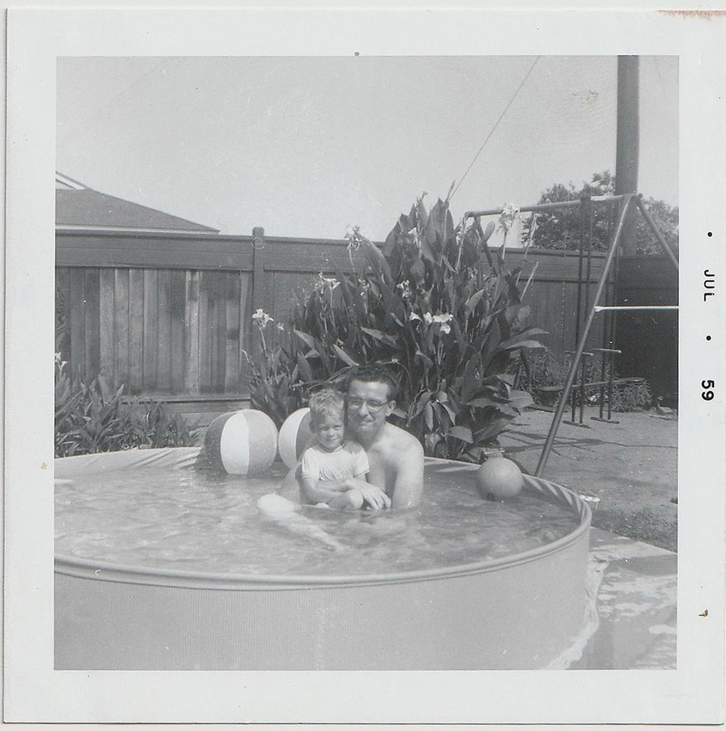 Father and Son in Backyard Pool