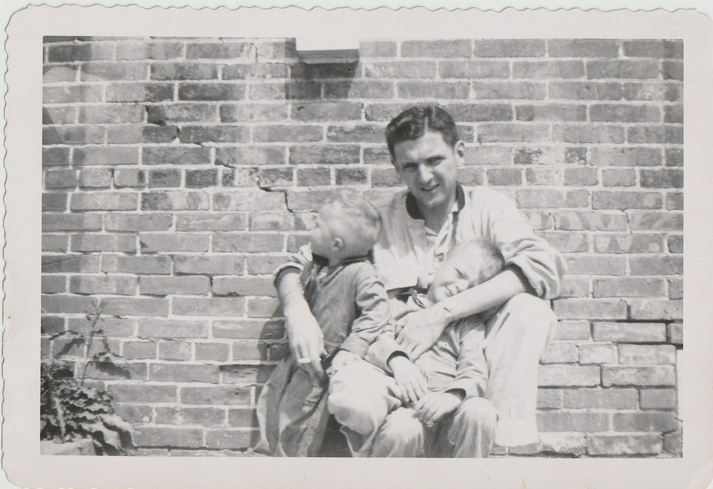 Father and Sons in Front of Brick Wall