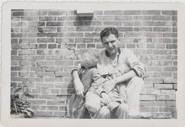 Father and Sons in Front of Brick Wall