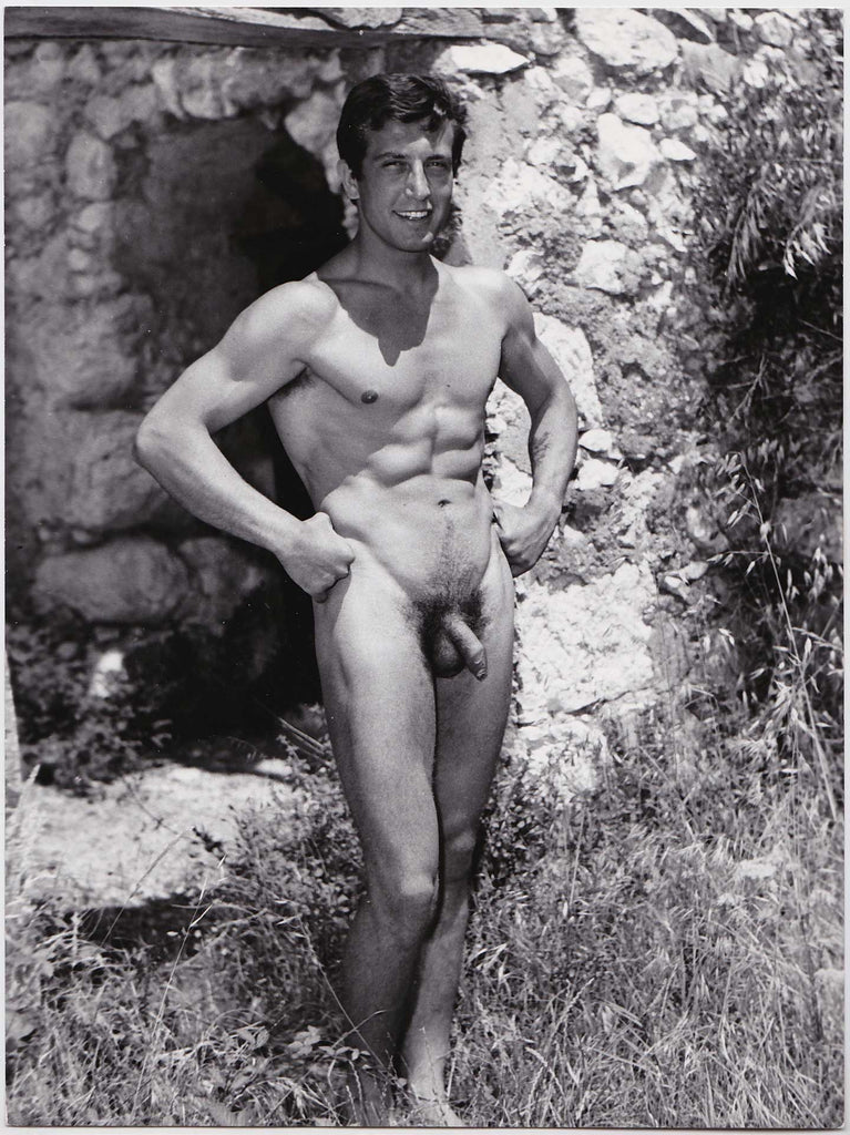 Vintage physique photo by Jean Ferrero. The handsome model standing arms akimbo is identified as "Moret." 