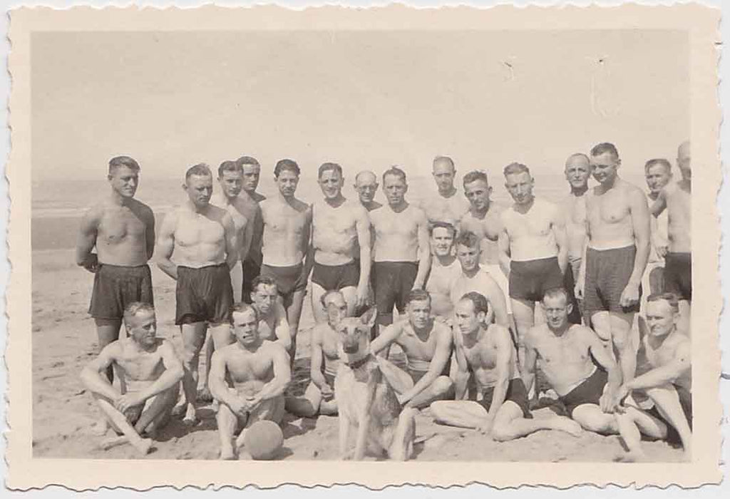 Vintage gay snapshot Group of guys on the beach with a handsome German Shepard front and center.