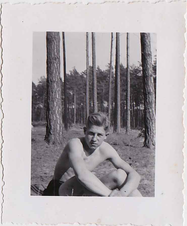 Handsome guy in shorts sits in a forest vintage gay snapshot
