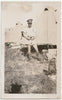 Vintage sepia photo Handsome studly soldier identified on verso as "Heals" poses in front of a row of tents with thumbs hooked onto his belt