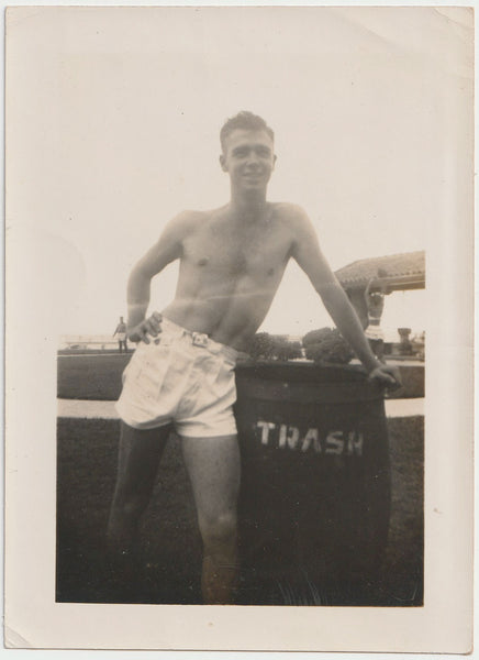 Jimmie at Daytona Beach standing next to trash bin. Vintage gay photo 1946