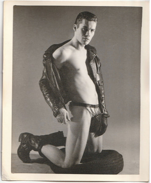 Leather Man Kneeling on Tire: Kris Studio vintage gay photo