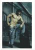 Tough guy strips to the waist in this vintage gay photo by Montreal-based photographer Carlos Quiroz (AKA Lobo Studios)