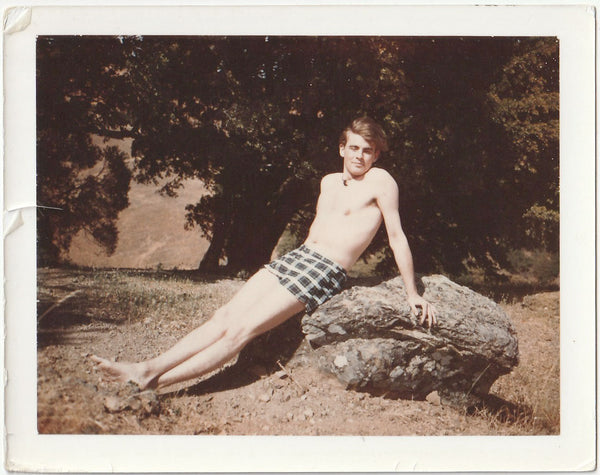 Handsome, long-legged guy in swimsuit sunning himself on a rock.
Vintage gay photo.