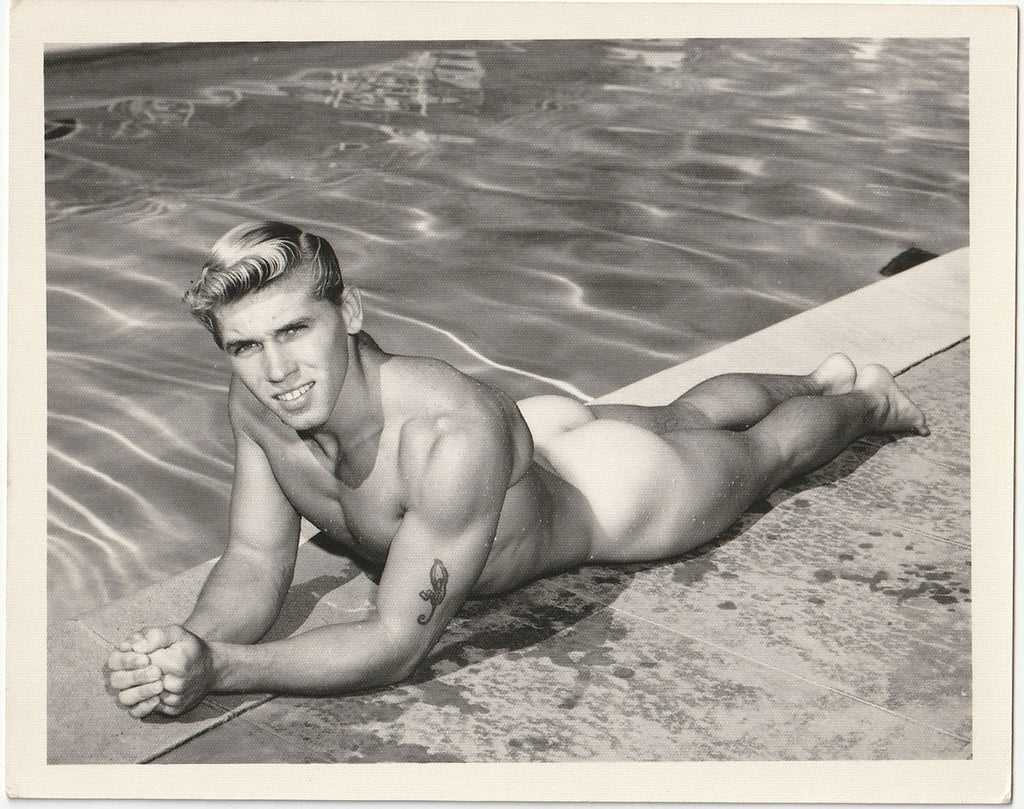 Vintage gay physique photo David Zurborg lying next to swimming pool, Bruce of LA