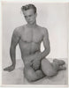 Vintage physique photo In a pose very similar to Copenhagen harbor's Little Mermaid, this cute but shy young guy places a hand in front of his genitals.