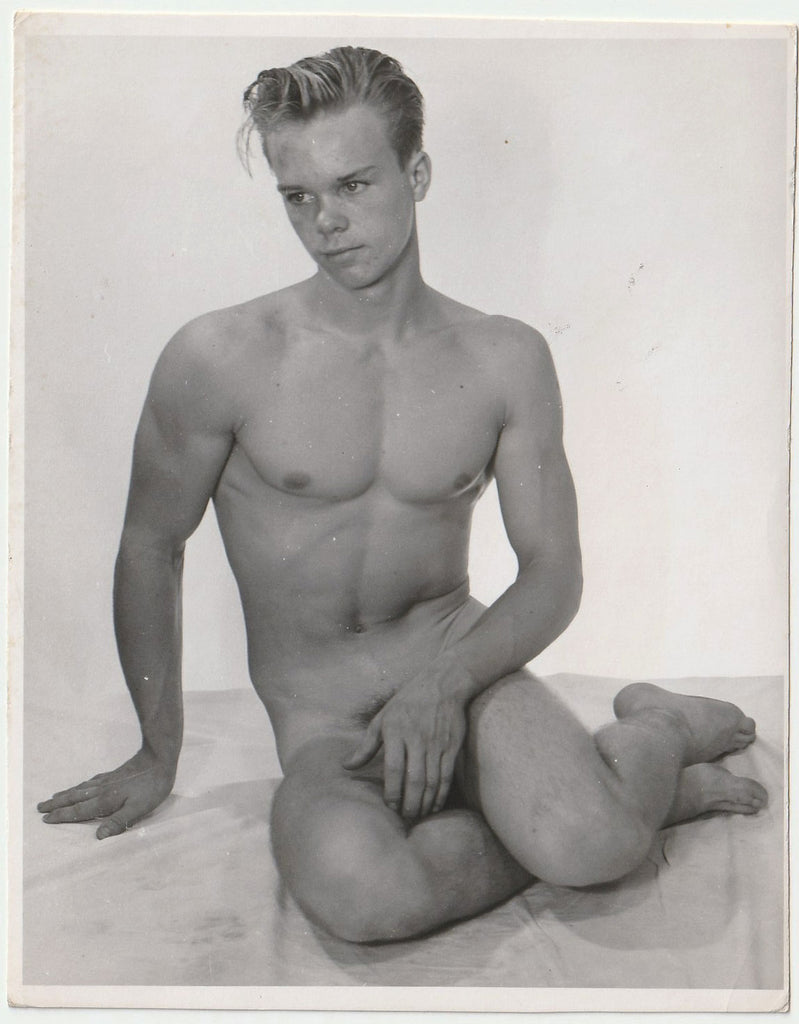 Vintage physique photo In a pose very similar to Copenhagen harbor's Little Mermaid, this cute but shy young guy places a hand in front of his genitals.