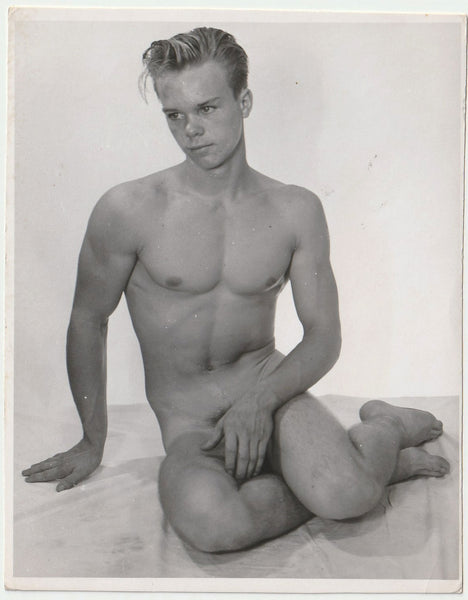 Vintage physique photo In a pose very similar to Copenhagen harbor's Little Mermaid, this cute but shy young guy places a hand in front of his genitals.