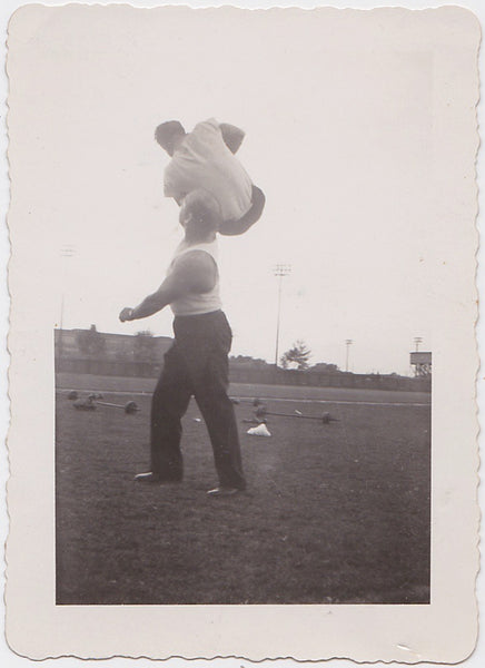 Vintage photo Man Lifting a Guy with One Arm