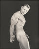 Vintage physique photo by Dave Martin. Muscular Tom Fine flexes his triceps in this stunning studio shot. 