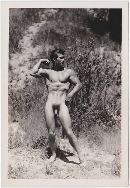 Handsome male nude poses in the rugged chaparral. Vintage physique photo