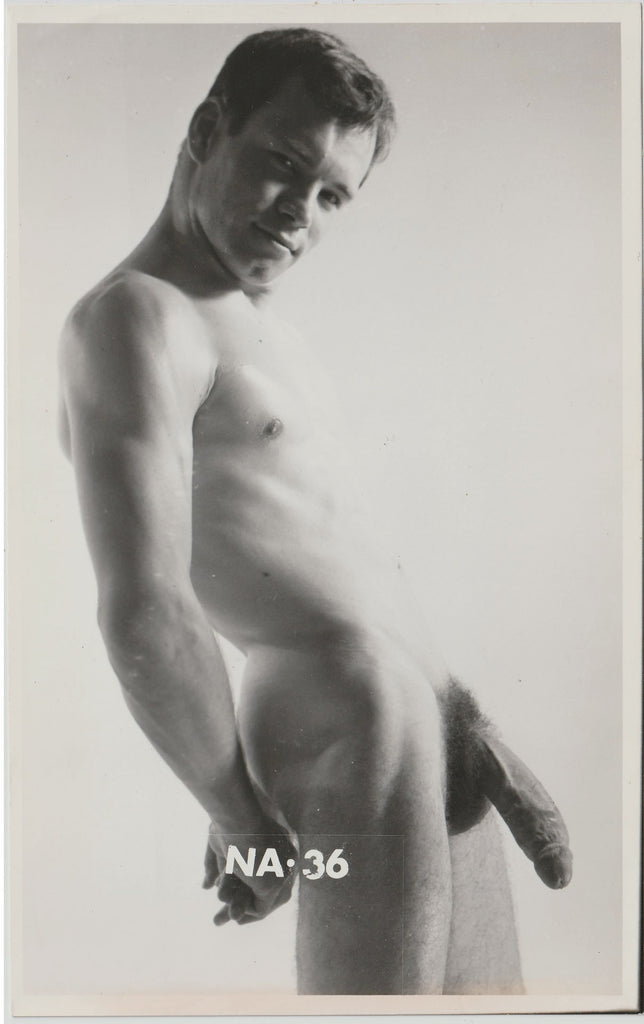 Black and white vintage physique photo of a handsome nude male model with the text 'NA-36' printed at the bottom.