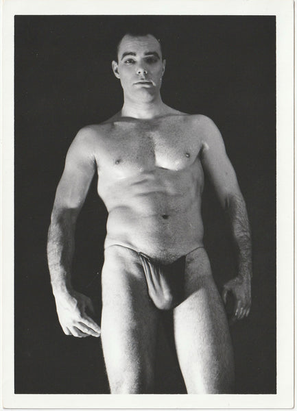 A black and white physique photograph of male model wearing a dark posing strap, Art Ullrich.