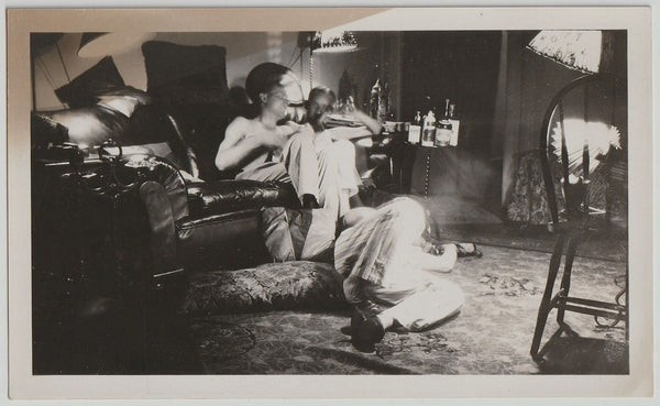 Strange and wonderful photo of three guys and a lot of empty booze bottles. 