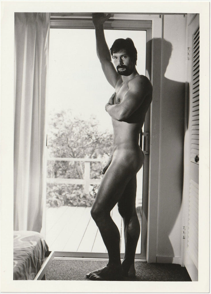 Studly "Brand" stands before the bedroom sliding glass door.  Vintage gay photo with Target Studios stamp.