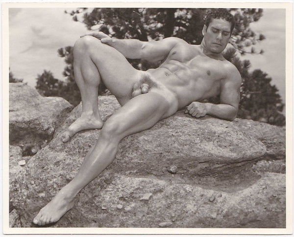 Vintage physique photo by Don Whitman / Western Photography Guild. Muscular male nude relaxes on a boulder. 