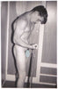Young guy at home training his biceps in the nude. vintage gay photo