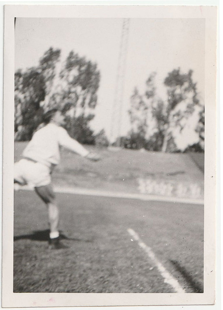 Has he just thrown a discuss or shotput? Blurry but strangely fascinating photo. ID on verso: "Ratzy."
