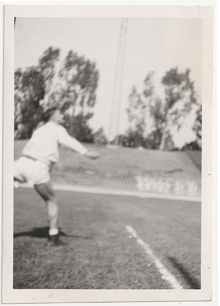 Has he just thrown a discuss or shotput? Blurry but strangely fascinating photo. ID on verso: "Ratzy."
